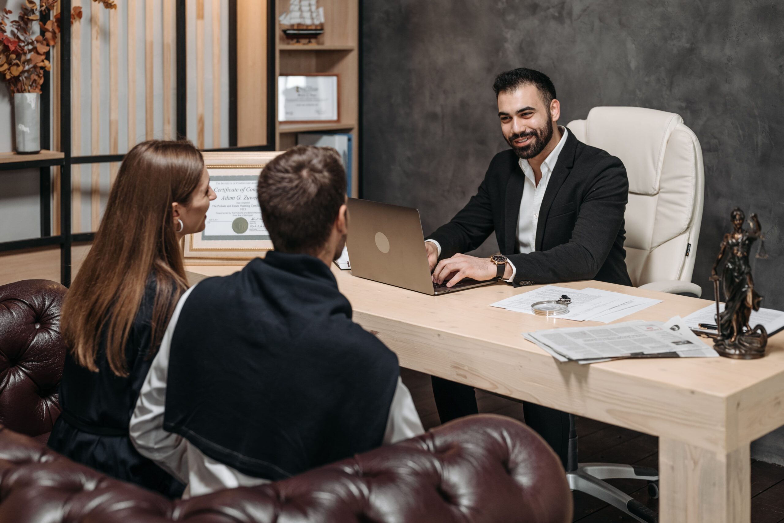A Couple Talking To A Lawyer During A Legal Consultation, Representing The Planning And Drafting Of Prenuptial And Postnuptial Agreements In Illinois.